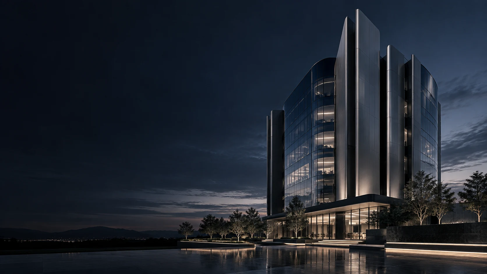 Contemporary corporate building with silver fins and reflective glass at blue hour